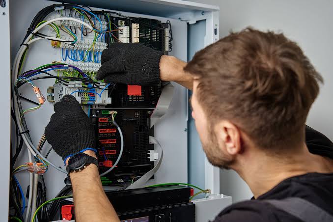 reliable electrician inspecting board